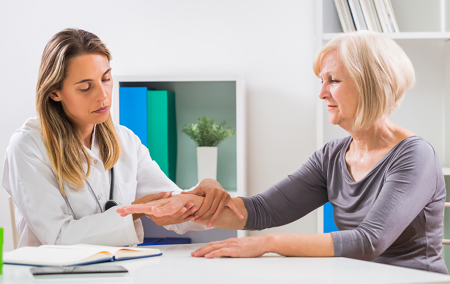 Female-physician-examining-senior-female-patient’s-wrist
