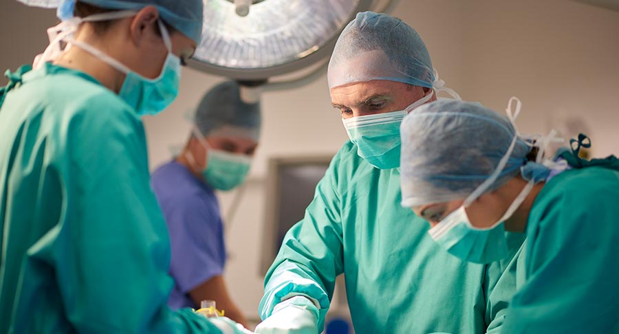 Group-of-surgeons-in-an-operating-room-performing-a-surgical-procedure