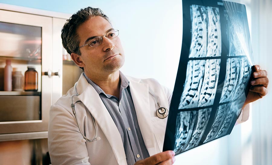 Physician-analyzing-MRI-scan-of-the-spinal-cord