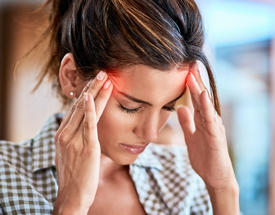 Woman-experiencing-a-headache-and-touching-her-temples